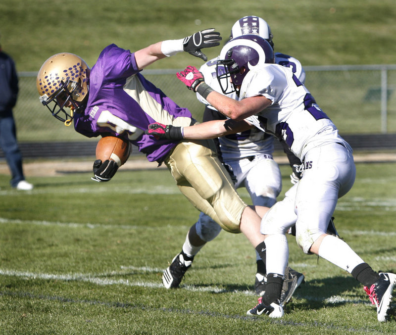 Liam Hobbins of Cheverus breaks away from Trey Thomes, foreground, and Kenny Sweet of Deering to score in the third quarter Saturday. Top-ranked Cheverus will open the Western Class A playoffs at home against Windham next Saturday.