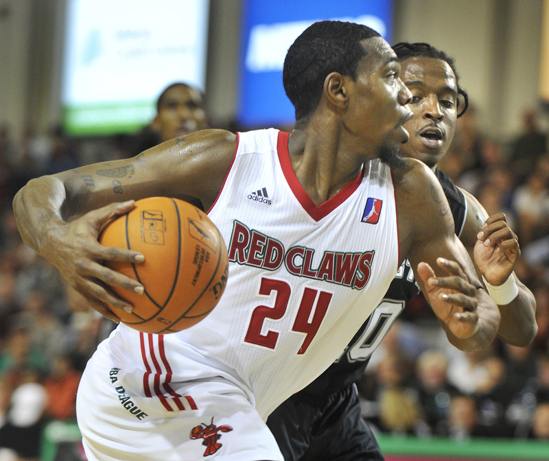 Red Claw Paul Harris drives hard to the basket defended by Austin's Carldell Johnson Friday night at the Portland Expo.