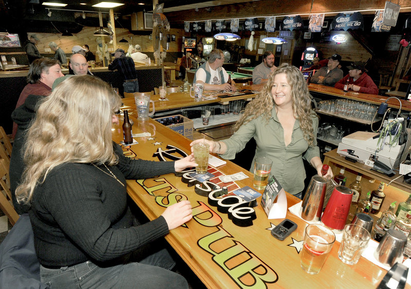 Bartender Misty Fisher serves customers at Riverside Sports Pub in Bath.