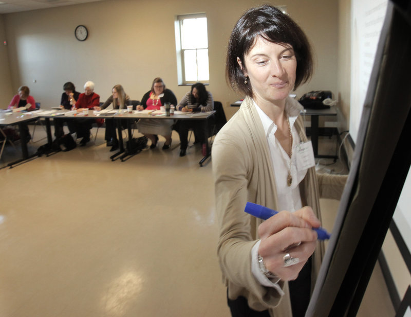 Facilitator Courtney Knapp jots down examples during a brainstorming session Saturday.