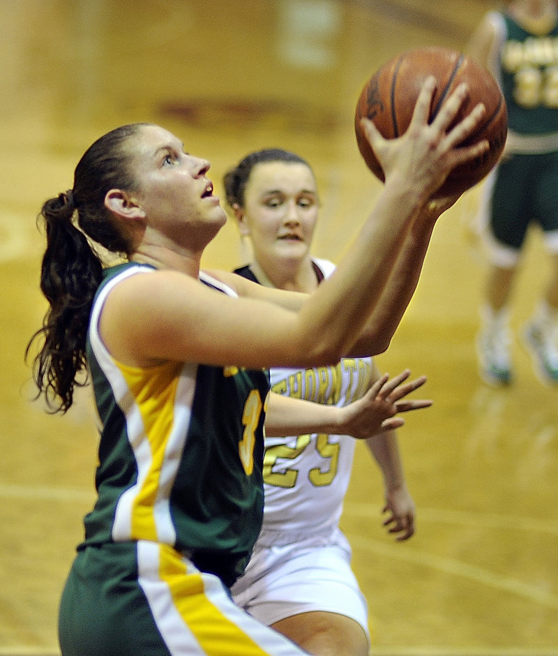 Rebecca Knight, who scored 8 of her 12 points in the first quarter Wednesday night, heads to the basket on a breakaway steal as Olivia Shaw of Thornton Academy attempts to close in. McAuley’s defense led to a 46-21 victory.