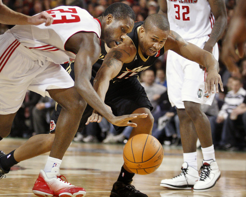 Champ Oguchi of the Maine Red Claws, left, and Kyle Spain of Erie compete for a loose ball Thursday night at the Portland Expo.