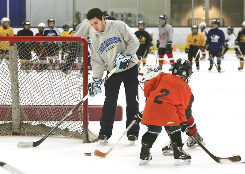 Carlos Amestoy of the University of Maine hockey team plays goalie during a three-on-three scrimmage in Falmouth.