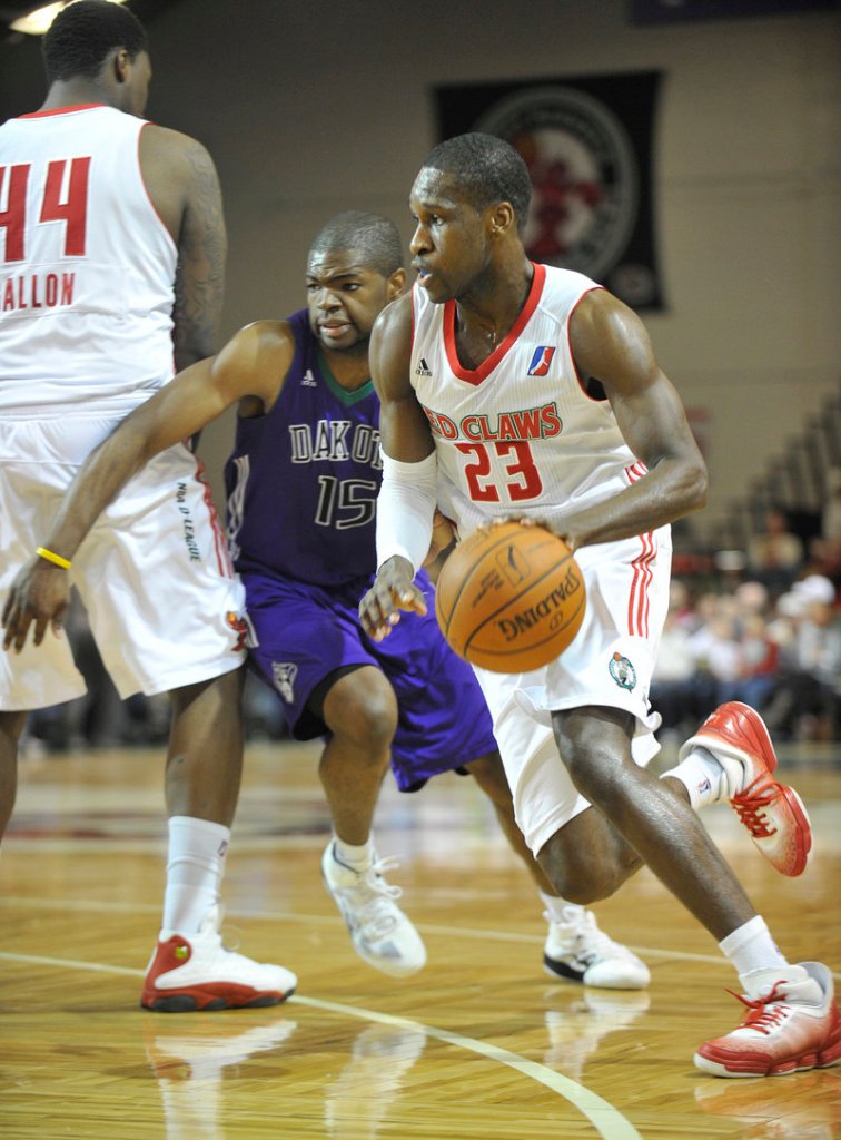 Champ Oguchi of the Red Claws uses a screen set by Tiny Gallon to elude Darren Cooper of the Dakota Wizards. The Red Claws had a six-game home winning streak snapped.