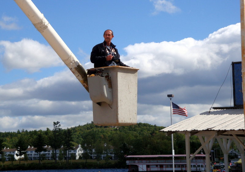 Brad Bradstreet gets a lift in a bucket to take a photograph.