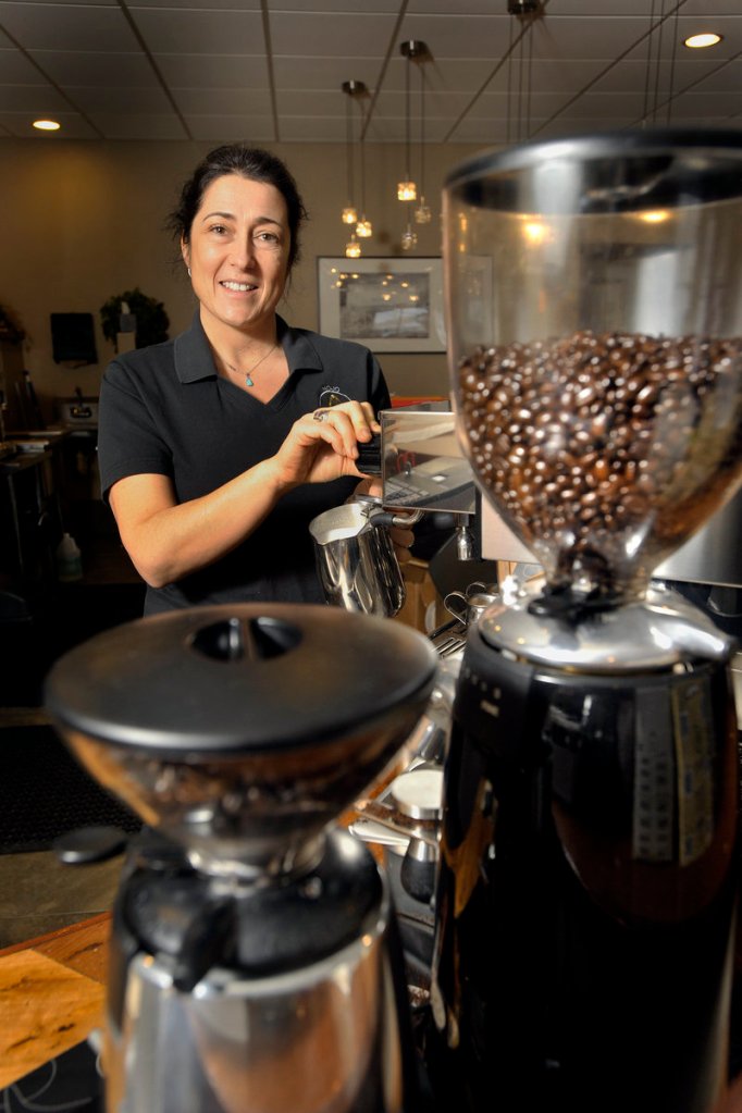 Jacquelin Bradley, owner of the Mojo Health Bar, prepares a latte for a customer. She opened the business because she “wanted to offer a healthier alternative to the things we all enjoy each day, like a good cup of coffee ...”