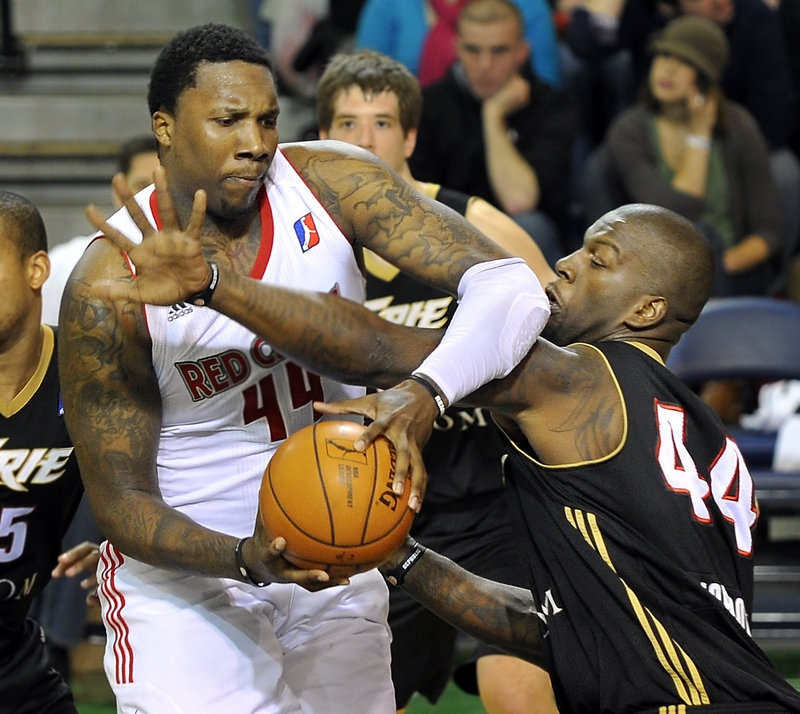 Maine’s Tiny Gallon tries to muscle past Ivan Johnson of the Erie BayHawks in a 113-109 loss at the Portland Expo on Friday. Gallon had 22 points and helped hold Johnson to 12.