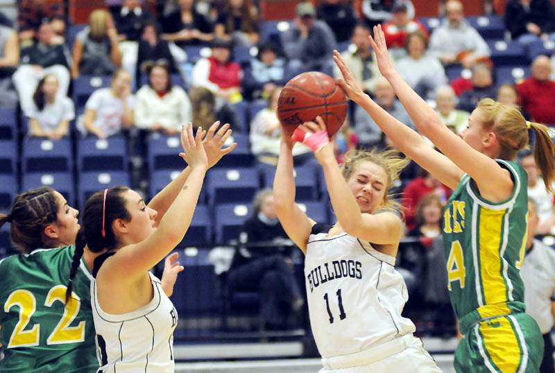 ALL IN: Hall-Dale High School’s Kristen Moody, second from right, gets blocked by Livermore Falls High School’s Annika Durrell as Livermore Falls’ Micaela Baron, left, and Hall-Dale’s Wendy Goldman look on during the Mountain Valley Conference championship game Monday in Augusta.