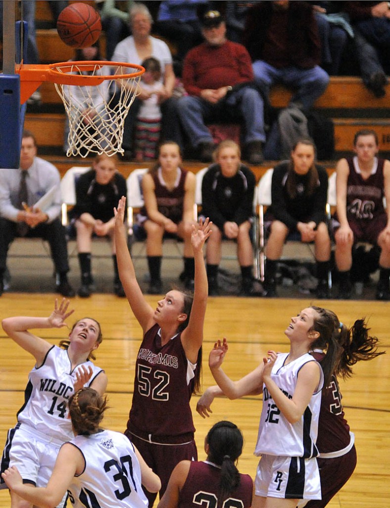 WAITING AROUND: Nokomis’ Danielle Watson, center, looks for the defensive rebound against Presque Isle in the Eastern Class B semifinals Wednesday at the Bangor Auditorium. Nokomis will play in its second straight Eastern B final when it faces Medomak Valley at 7:05 tonight.