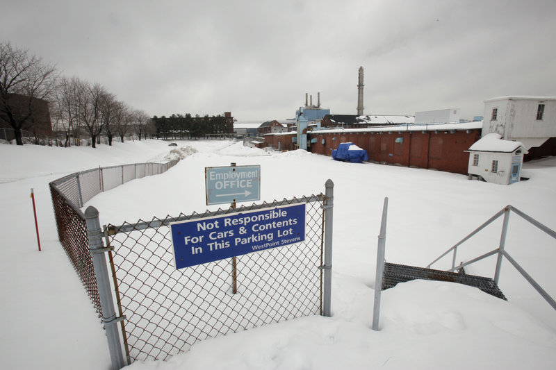 This parking lot in the heart of the Biddeford mill complex is one of the proposed areas for a parking garage downtown. “New parking is crucial,” City Manager John Bubier said Tuesday.