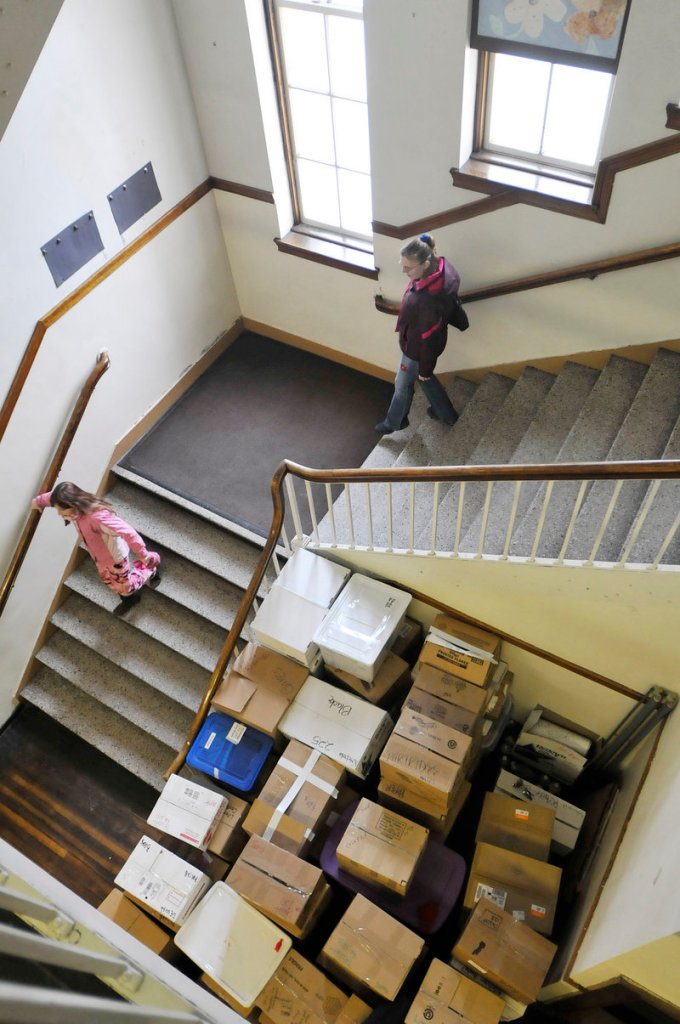 Boxes are stacked in the halls of the Clifford school as visitors walk around during the open house Sunday.