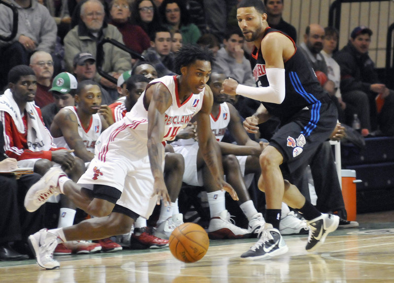 Jamar Smith moves to the basket around Tony Bobbitt of Springfield on Sunday. Smith scored 20 points as the Red Claws beat the Armor, 97-96.