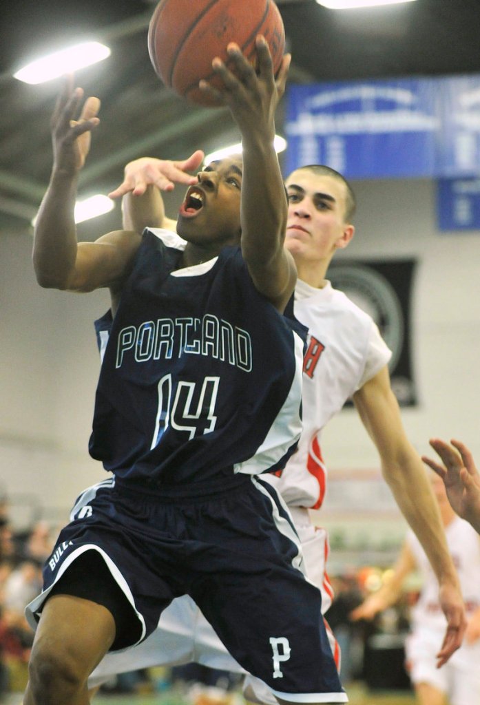 Portland freshman Jayvon Pitts-Young, who finished with 16 points, scores on a layup in front of Logan Gaddar of South Portland during Portland's 69-45 victory Friday night at the Portland Expo.