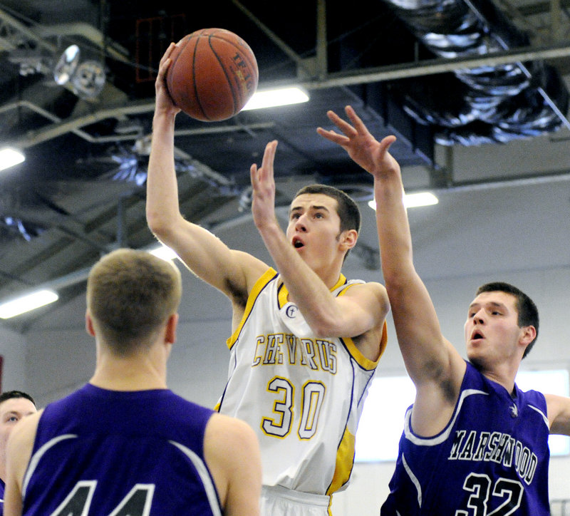 Griffin Brady of Cheverus finds room for a shot Friday night between Addison Casey, left, and Jack Verrill of Marshwood during Cheverus’ 52-40 quarterfinal victory at the Expo.