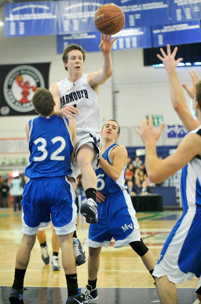 Josh Britten of Yarmouth dishes off Saturday after penetrating the lane against Jacob Theriault of Mountain Valley. Britten scored 28 points in a 77-52 victory that lifted the Clippers into the Western Class B semifinals.