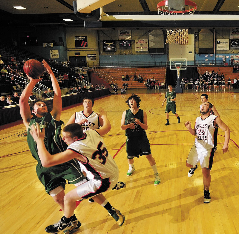 Ezekiel Hall of Rangeley is bumped by Raymond Petrin of Forest Hills while trying to shoot Saturday during their Western Class D quarterfinal at the Augusta Civic Center. Top-ranked Forest Hills escaped with a 54-51 victory.