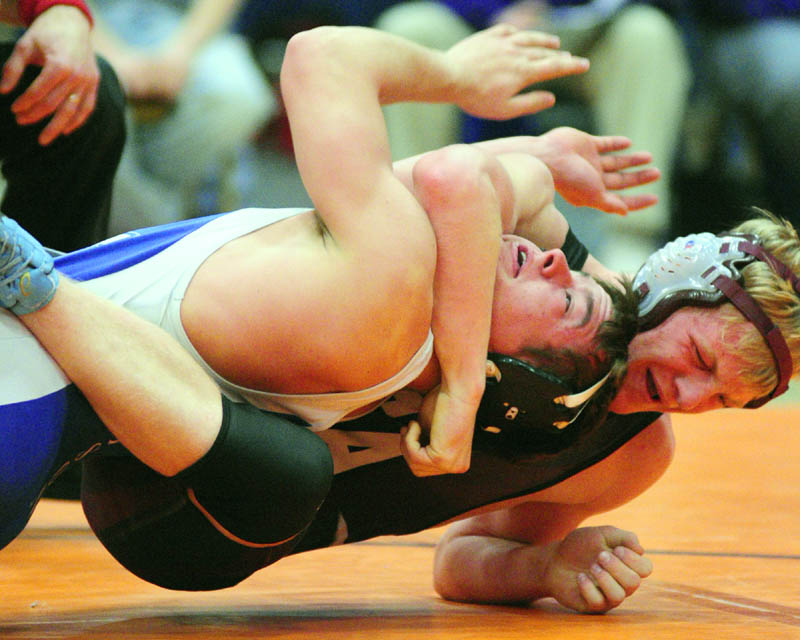 TOUGH SPOT: Madison’s Jacob Campbell, left, and Foxcroft Academy’s Wesley Stinson grapple in the 152-pound Class C championship match on Saturday night during the wrestling state championships at the Augusta Civic Center.