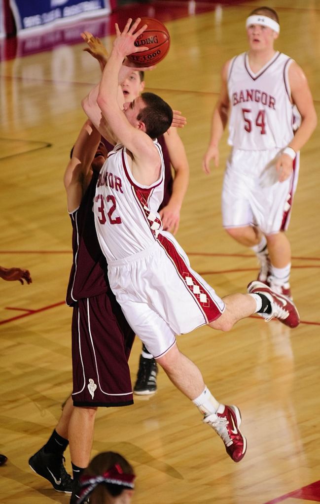 Zach Blodgett of Bangor shoots over Edward Little's Quin Leary during the Eastern Class A boys' basketball championship game Tuesday night at the Augusta Civic Center.