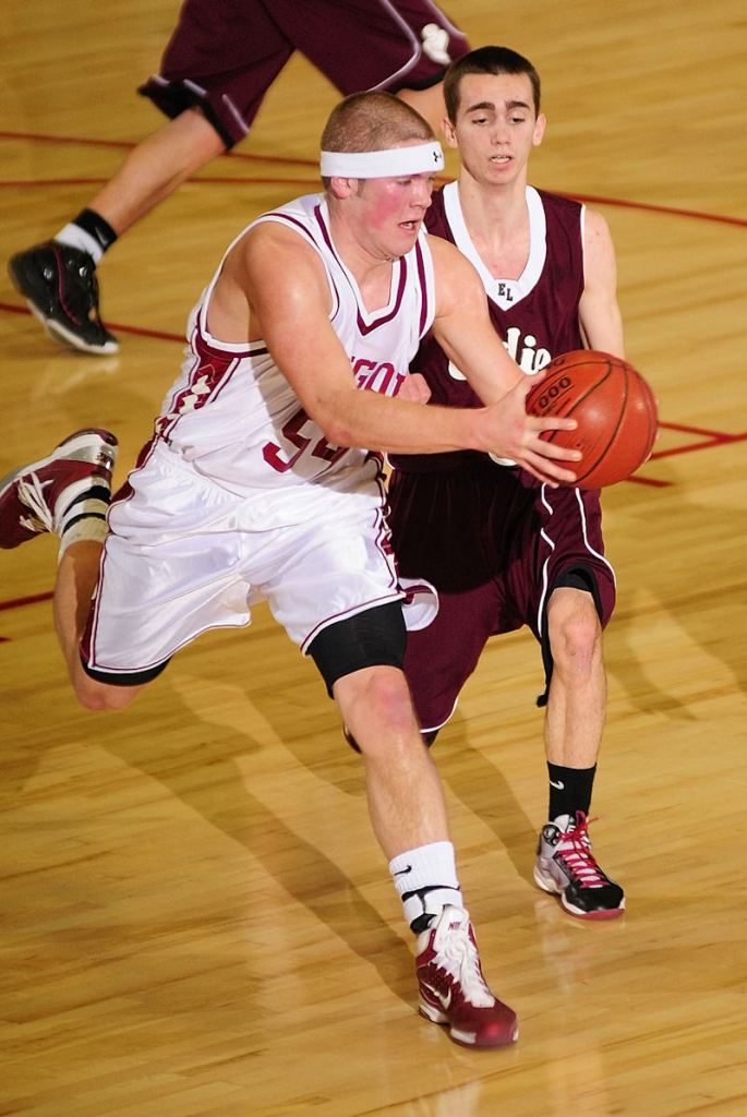 Bangor forward Josiah Hartley keeps an errant pass from going out of bounds just in front of Edward Little guard Timmy Mains.