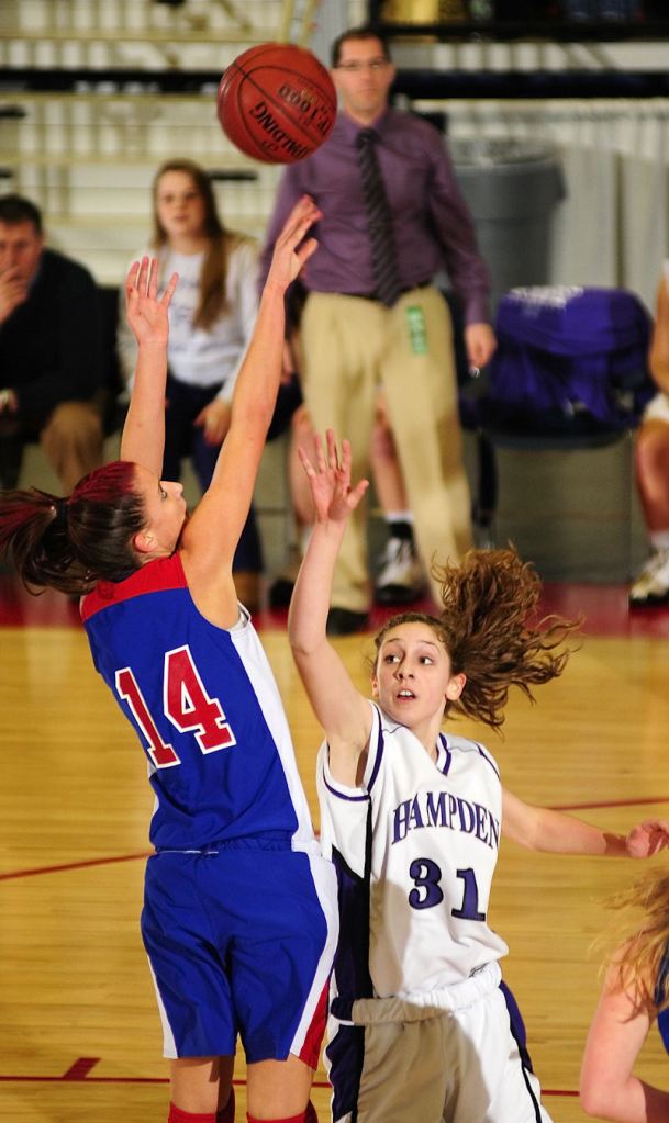 Megan Pelletier of Messalonskee shoots over Hampden's Whitney Moore during the Eastern Class A girls' basketball championship game Tuesday night at the Augusta Civic Center.