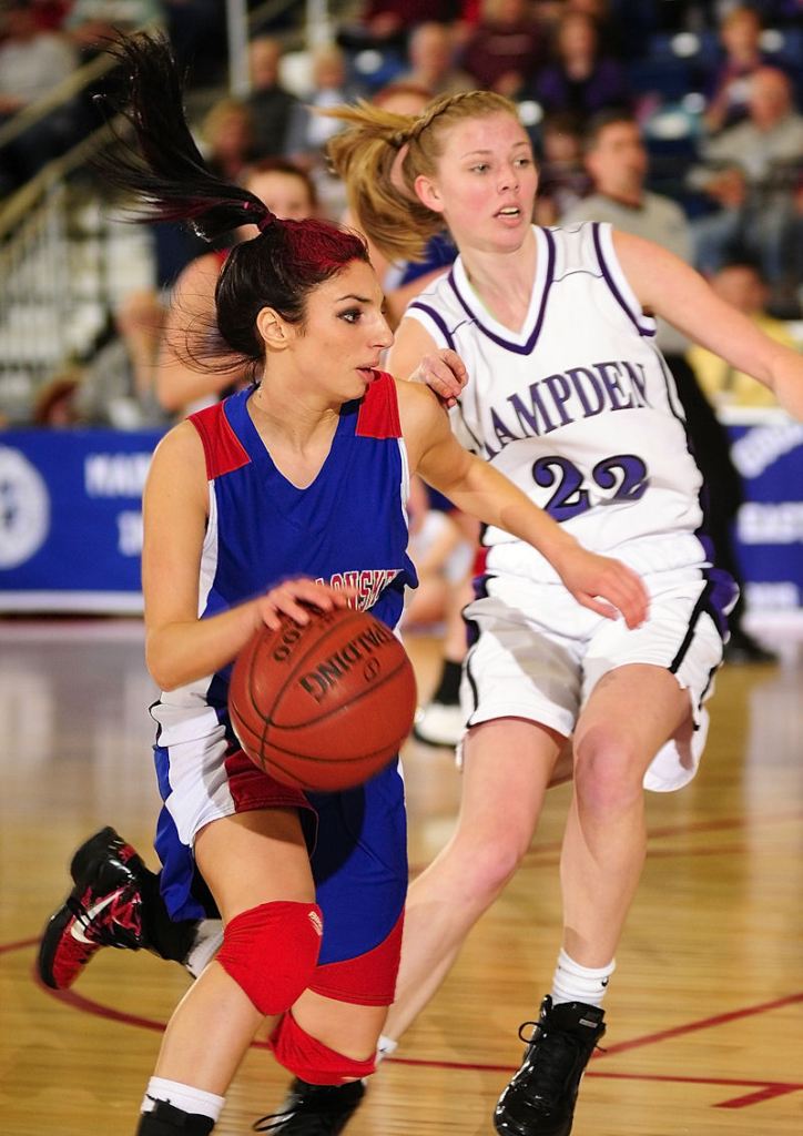 Mary Badeen drives around Hampden guard Jordan Maxwell in the first half. Hampden won 62-40 and will play McAuley for the state championship Saturday at the Augusta Civic Center.