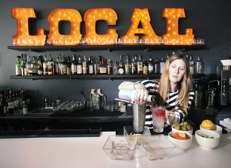 Merrilee Paul, co-owner of 50 Local in Kennebunk, mixes a cocktail. Paul says the food and drink menus are constantly in flux with the changing climate to take advantage of the best local ingredients.