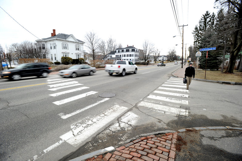 The crosswalk at Cleveland Street in Saco, left, where a pedestrian was struck and killed by a minivan last summer, crosses a four-lane stretch of Main Street traveled by 25,000 vehicles a day. This crosswalk and one at nearby Summer Street will be removed as soon as weather permits.