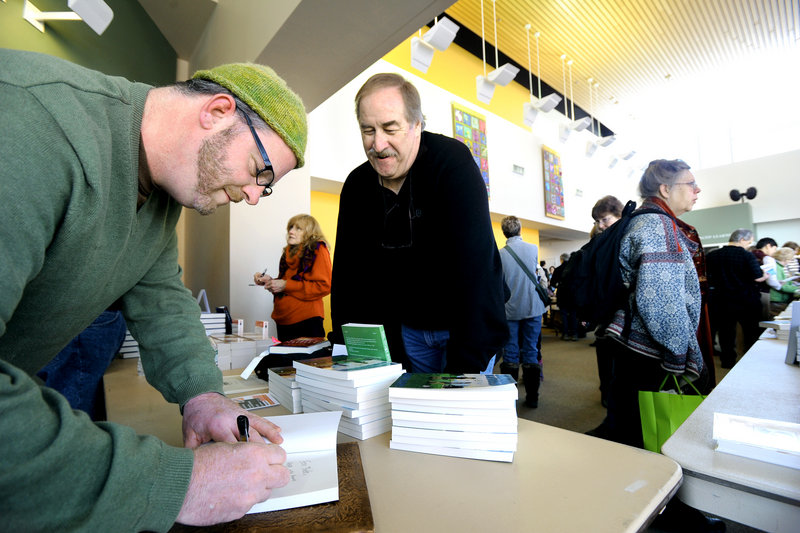 Author Crash Barry signs his book, "Sex, Drugs and Blueberries," for Bob Gilding of Windham at the annual Maine Festival of the Book at USM in Portland.