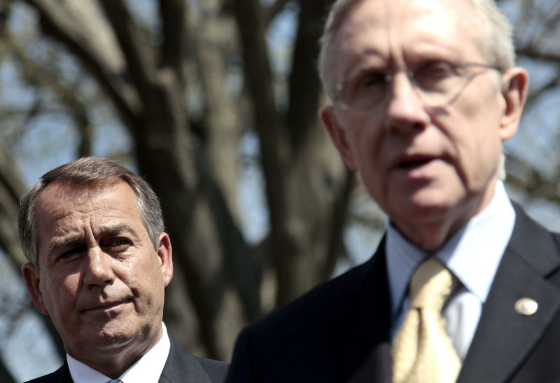 House Speaker John Boehner, R-Ohio, left, listens Thursday as Senate Majority Leader Harry Reid, D-Nev., speaks to reporters outside the White House after their meeting with President Obama on the budget impasse.