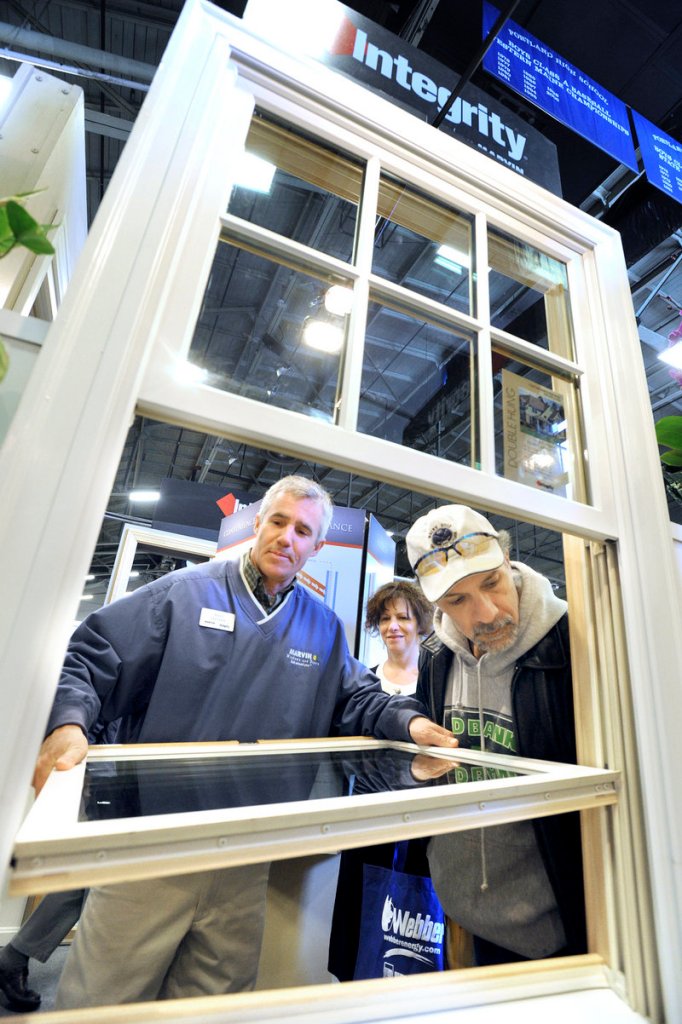 Matt Stetson of Marvin’s shows replacement windows to Lisa and Paul Naseef of Cape Elizabeth at the Portland Home Show, which is expected to draw 12,000 visitors this weekend.