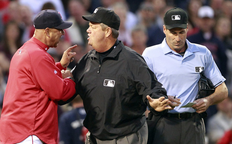 Umpire Joe West gets between Boston Manager Terry Francona, left, and home plate umpire Angel Hernandez after Hernandez ejected Francona for arguing a balk in the second inning of Minnesota’s 9-2 win Friday in Boston.