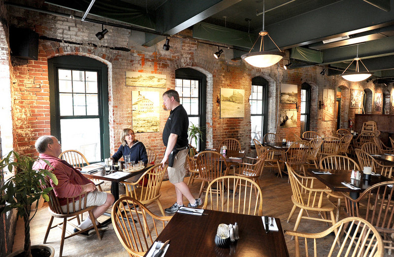 Aaron Lockwood waits on Todd and Nancy Erkman of Wiscasset at the Sea Dog Brewing Co. in Topsham.