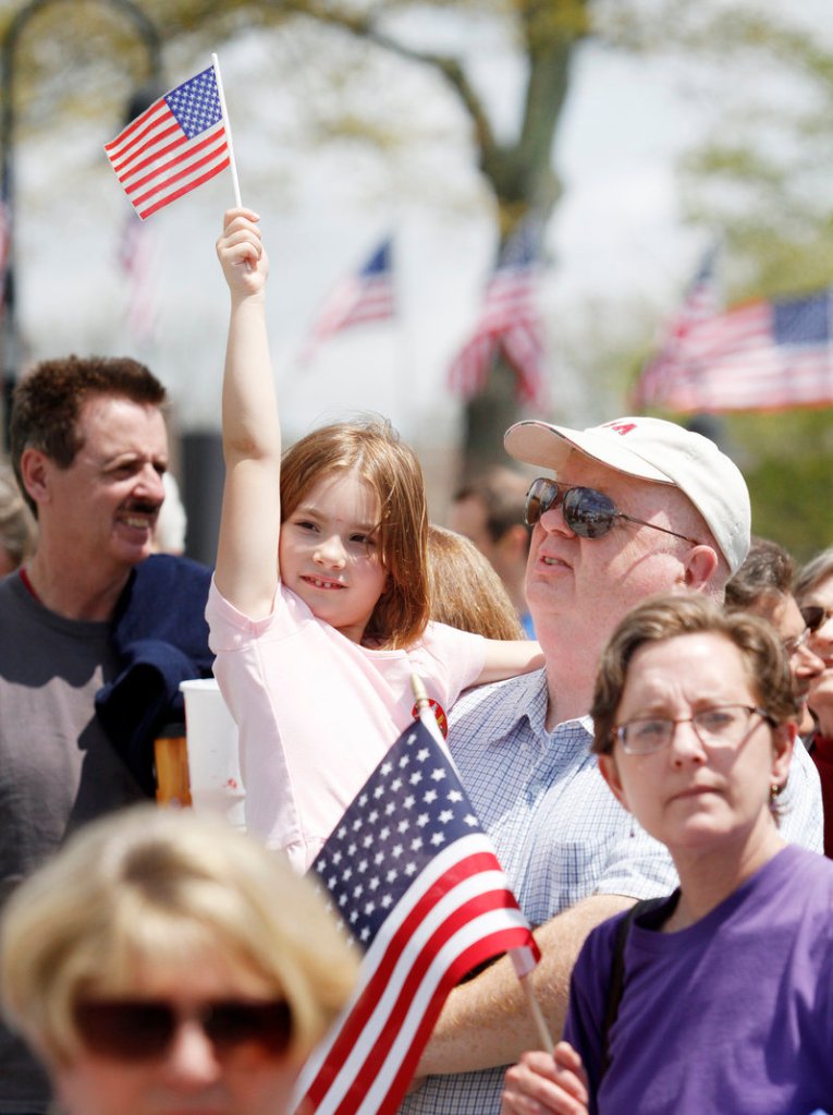 Ella Emery, 6, of Durham is accompanied by her aunt Debora Dillon of Freeport and grandfather Hugh Law of Saranac Lake, N.Y., on Saturday.