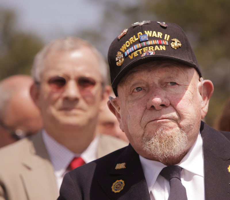 Arnold Wilkie, 87, who watched the flag raised for the first time when the Brunswick Naval Air Station opened in 1943, watches as it was lowered Tuesday. "I just can't believe it," Wilkie said. "It's too bad."