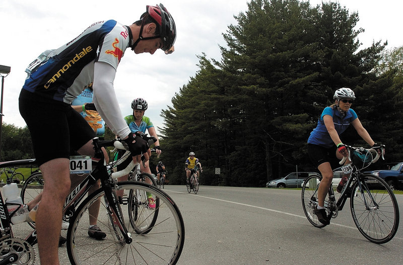 Nate Olsen of Albion adjusts his bike as other cyclists arrive at Colby College in Waterville on Saturday, the second day of Trek Across Maine, an annual American Lung Association fundraiser.