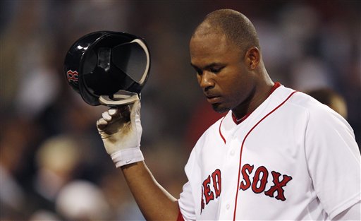 Boston's Carl Crawford takes off his batting helmet as he heads back to the dugout after striking out with two men on against the Kansas City Royals in the 11th inning Monday at Fenway Park in Boston.