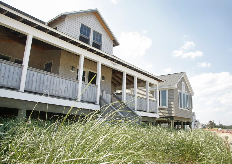 Joe and Kathy Hardman’s replacement cottage, built in 2008, sits 6 feet above the sand on pilings driven 20 feet into the ground. It was designed using a cross shape, creating more surface for windows providing ocean views and more living space on the porch.