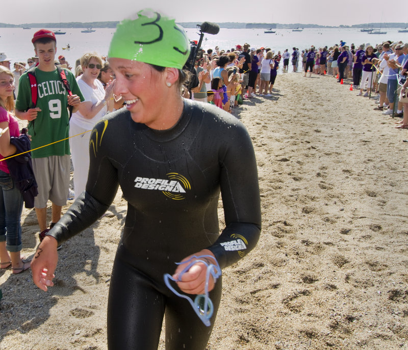 Kristen Desrosiers, 20, of Gorham scampers onto dry land Saturday after winning the women s division of the Peaks to Portland for the second straight year. She was the 20th overall finisher in a field of 279 swimmers.