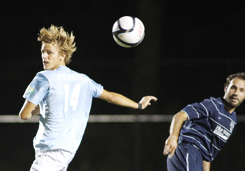 Brian Fekete, left, of the Phoenix heads the ball up the field in the first half. Portland’s season ended with its first home loss.