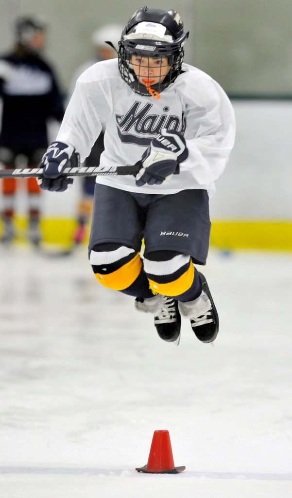 C.J. Imperiale jumps past a pylon during a skating drill at the weeklong Black Bear Hockey Camp.