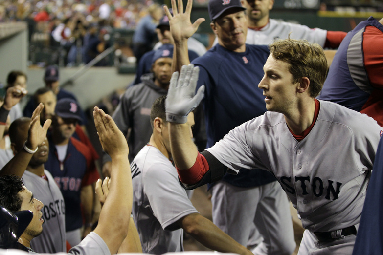 Boston shortstop Jed Lowrie is greeted in the dugout after hitting a solo home run against the Seattle Mariners in the fifth inning Friday night. David Ortiz and Josh Reddick also homered. The Red Sox won, 6-4.