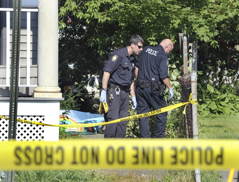 Portland police search an alley outside 4-6 Massachussetts Ave., where a man apparently was shot early Monday. The shooting is the first homicide of this year in Portland.