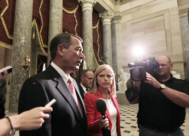 House Speaker John Boehner, R-Ohio, returns to his office after emergency legislation to avert a government default and cut federal spending passed a showdown vote in the House of Representatives in Washington on Monday.