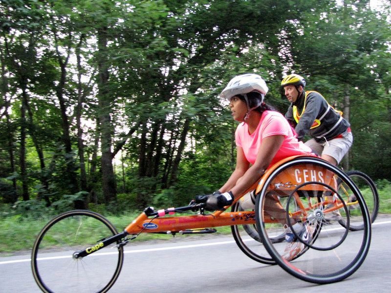 Christina Kouros, training with spotter Eric Topper of Maine Handicapped Skiing, is the favorite to win the women's wheelchair division of the Beach to Beacon 10K this morning. Kouros, a Cape Elizabeth resident, made her 10K debut in June, finishing in 49 minutes, 20 seconds.