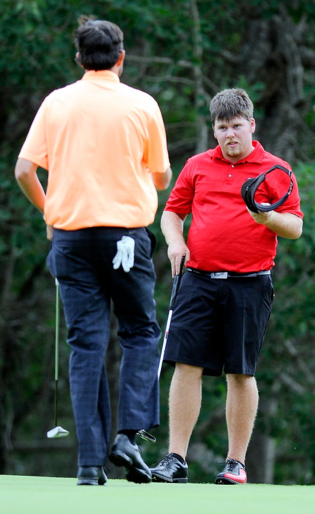 Ryan Gay, right, is approached by Matt Greenleaf as Greenleaf concedes on the 16th hole of the final round of MSGA match play at the Augusta Country Club in Manchester.