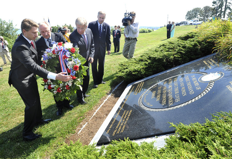 Russian delegates Andrey Bralnin, Sergey Emmanuilov and Stanislav Vtory lay a wreath on a plaque at the Eastern Prom to mark the 70th anniversary of Arctic convoys. During World War II, ships left Portland Harbor and braved many dangers to take supplies to Russia.