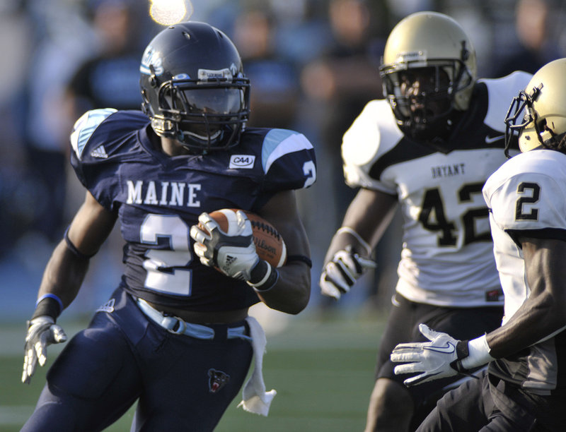 Pushaun Brown turns the corner and picks up yardage Saturday during the University of Maine’s 28-13 season-opening win against Bryant. Brown gained 146 yards.