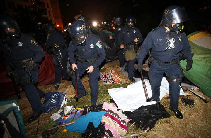 Oakland police search tents in Frank Ogawa Plaza as they disperse Occupy Oakland protesters today in Oakland, Calif. City officials had originally been supportive of the protesters, but the city later warned tthem that they were breaking the law and could not stay in the encampment overnight.