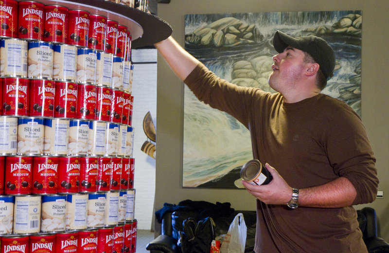 Jonah DeWaters of Oak Point Associates works on a replica of West Quoddy Head Light during the Canstruction competition. The sculptures will remain on display through Friday’s art walk. Canstruction is an international nonprofit with contests around the globe to create sculptures with canned goods.