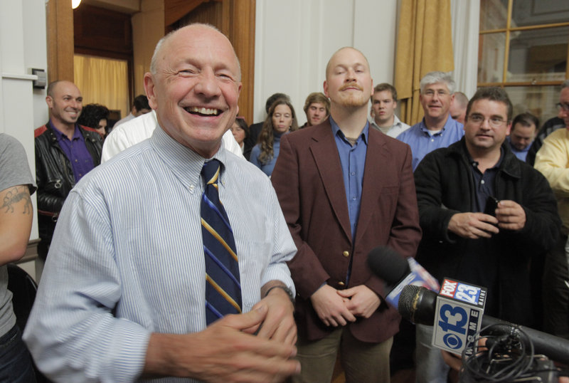 Michael Brennan stands with vote-watchers and rival candidates Wednesday night at City Hall after becoming Portland’s first elected mayor in 88 years following a daylong count of ranked-choice votes.